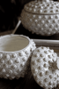 SET OF TWO ROUND KNOBBY WHITE CERAMIC  CANISTERS