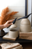 SET OF TWO CLAY CANISTERS WITH WOODEN BIRD HANDLES